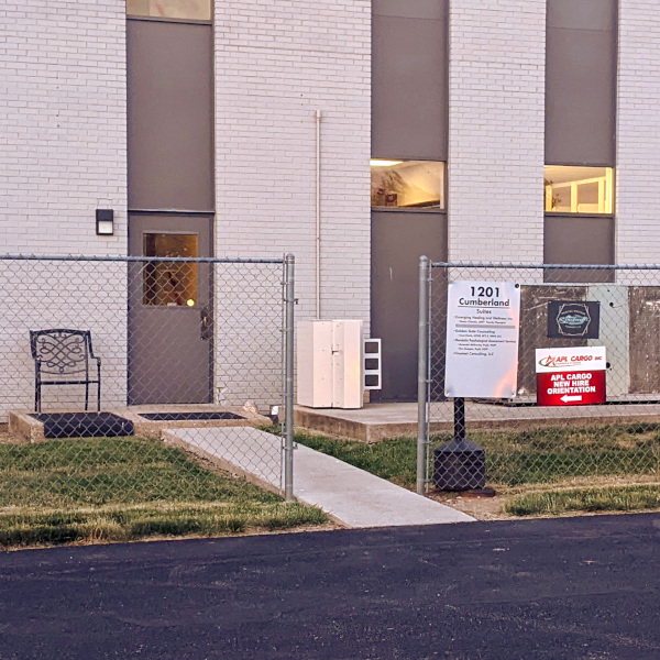 exterior photo of the 1201 Cumberland building indicating which door to come in